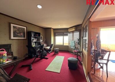 Room with exercise equipment and bookshelf