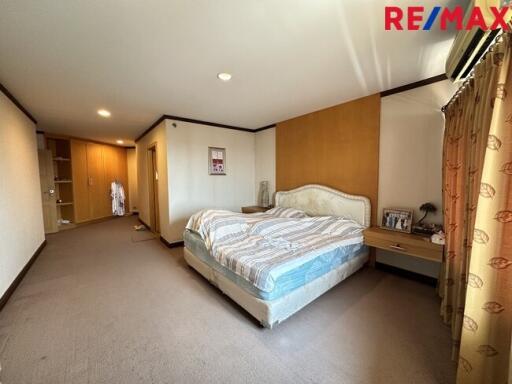 Spacious bedroom with a large bed and built-in wardrobe