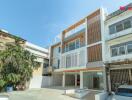 Modern three-story residential building exterior with a driveway