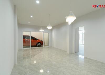 Spacious living room with tiled floor and modern lighting