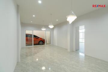 Spacious living room with tiled floor and modern lighting