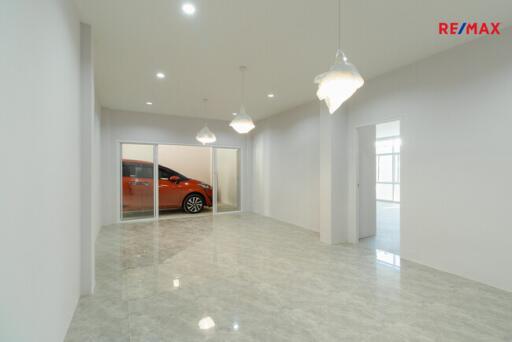 Spacious living room with tiled floor and modern lighting