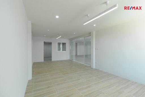 Spacious living room with modern flooring and large windows