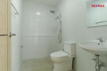 Modern bathroom with shower, sink, and toilet