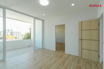 Modern living room with wooden flooring and large windows