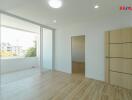 Modern living room with wooden flooring and large windows