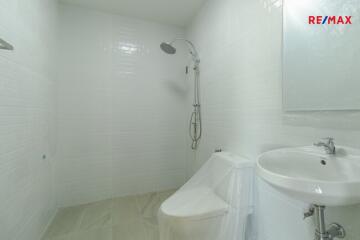 White bathroom with shower and sink