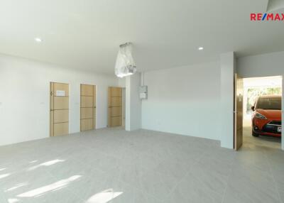 Spacious living area with modern lighting and access to garage