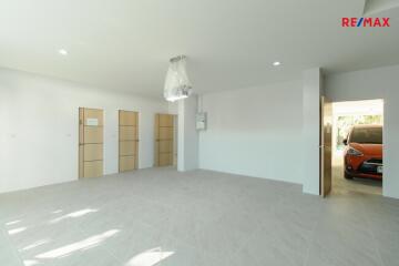 Spacious living area with modern lighting and access to garage