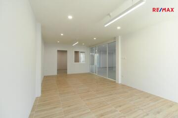 Spacious living room with wooden flooring and bright lighting