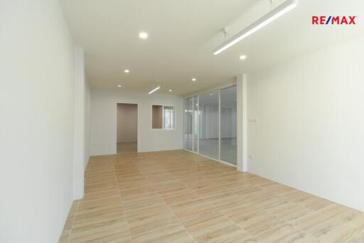 Spacious living room with wooden flooring and bright lighting