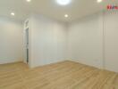 Unfurnished room with wooden floor and white walls