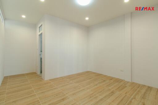 Unfurnished room with wooden floor and white walls