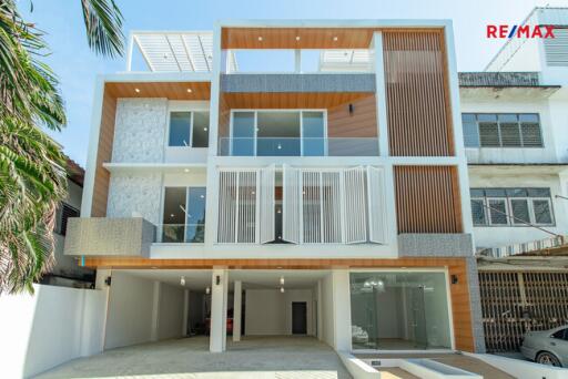 Modern multi-story building with large windows and wood accents