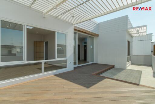 modern house exterior with large deck and sliding glass doors