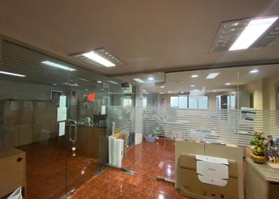 Modern office with glass partitions and tiled floor