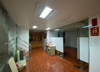 Office lobby area with staircase and glass doors