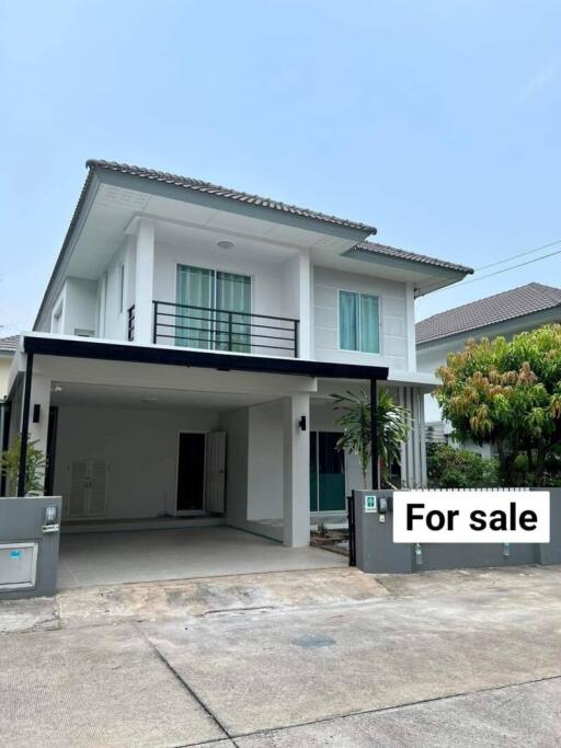 Exterior view of a two-story house with a carport and 