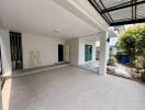 covered garage area with tiled floor and open surroundings