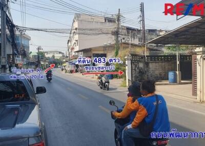 Outdoor neighborhood street view with people riding motorcycles and road signs