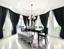 Elegant dining room with large windows, chandelier, and sophisticated decor