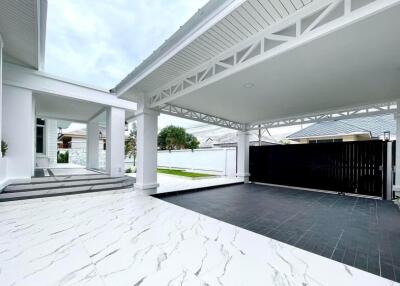 Modern covered carport with adjacent house entrance