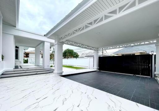 Modern covered carport with adjacent house entrance