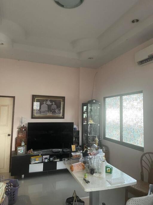 Spacious living room with a TV and display cabinet