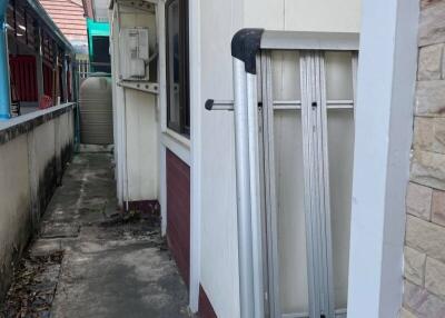 Side walkway with air conditioning units and a ladder