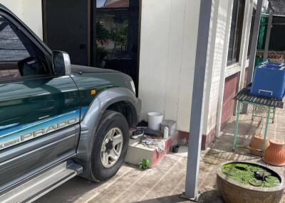 A carport with a vehicle parked next to a building