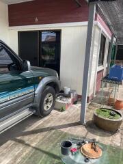 A carport with a vehicle parked next to a building