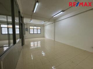 Empty room with tiled floor and fluorescent lighting