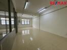 Empty room with tiled floor and fluorescent lighting