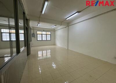 Empty room with tiled flooring and fluorescent lights