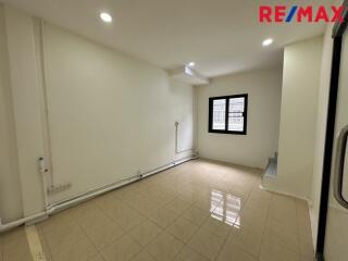 Modern living room with tiled flooring and recessed lighting