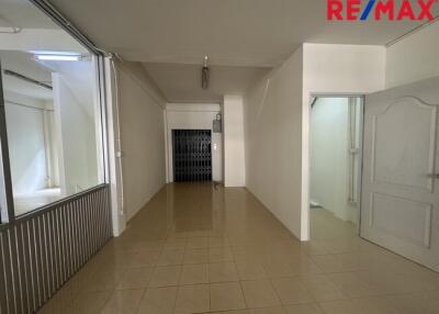 Empty interior space with tiled floor and white walls