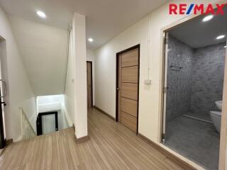 Second floor hallway with bathroom access and stairway