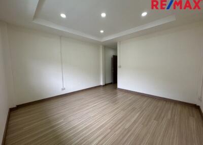 Empty room with wooden flooring and recessed lighting