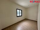 Empty room with a window and wooden floor