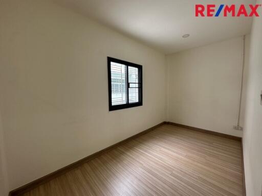 Empty room with a window and wooden floor