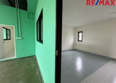 Interior split view of two rooms, one with green walls and the other with white walls.