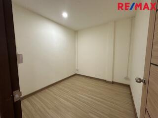 Empty room with wooden floor and white walls