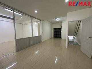 Spacious interior with tiled flooring and glass partition