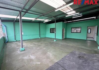 Empty industrial space with green walls and concrete floor