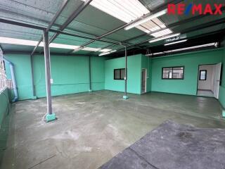 Empty industrial space with green walls and concrete floor