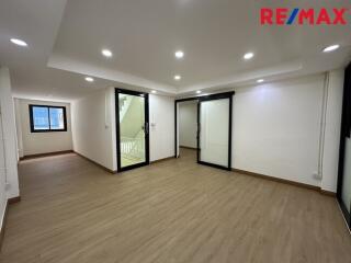 Spacious living area with wooden flooring and ample lighting