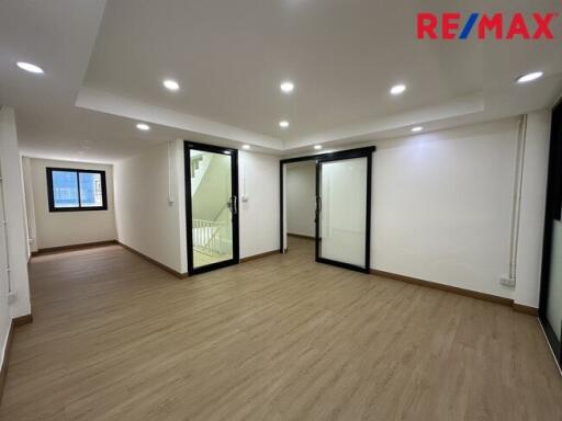 Spacious living area with wooden flooring and ample lighting