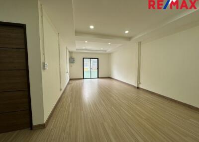 Spacious and well-lit living area with wooden flooring