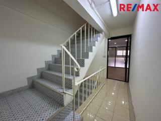 staircase leading to an upper floor with tiled flooring