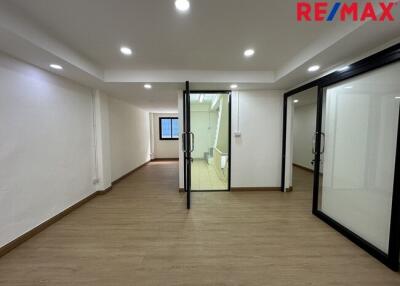 Empty spacious room with glass doors and wooden flooring